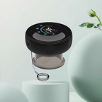 Electric cupping massager lifestyle shot on white pedestal with green botanical background