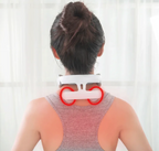 Woman wearing cervical neck massager from behind with red heat therapy circles on neck and shoulders